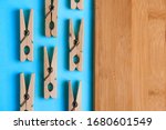 Wooden clothespins on a blue background with a Board for cutting products.Perfectionism.Symmetrically laid out items.Household.