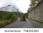 Landscape picture of a large stone blocking the road in Norway