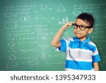 Small photo of Portrait of cute asian kid think Curious concept with calk board background