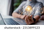 Small photo of 2024 creative concept, women holding light bulb 2024 numbers, 2024 number for creative thinking idea for starting new business concept.