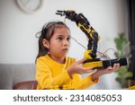 Small photo of STEM education concept. Asian students learn at home by coding robot arms in STEM, mathematics engineering science technology computer code in robotics for kids' concepts.