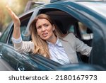 Small photo of Road rage traffic jam concept. Businesswoman is driving her car very aggressive