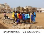 Small photo of DAKAR, SENEGAL – MARCH 14, 2022: Children football team in Dakar, Senegal, Africa. Active recreation, sport in Dakar, Senegal, Africa. African child, kid and football. Dakar landmark, cityscape. Group