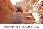 Small photo of Canyonlands National Park - USA - October 2016: 4x4 jeep offroading in ry arid canyon landscapes.