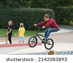 Small photo of Moscow, Russia - August 28, 2019: BMX in the city skatepark. Young man doing trick on the bike in summer day. Extreme sports is very popular among youth.