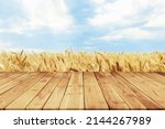Wooden Plank Empty Table For Products Display With Blurred Wheat Field and Blue Sky Background