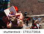 Small photo of 20 JANUARY 2020: old woman pray reading the sacred holy text veda from hinduism religion, city of haridwar, India.