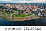 Small photo of Aerial Drone Fly Above Asuncion City Waterfront in Paraguay, Daylight Cityscape Panorama of South American River