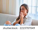 Small photo of Sad upset depressed crying melancholic woman sitting alone at home