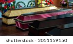 Small photo of Coffins in a funeral home, burial, death of a loved one, high mortality.
