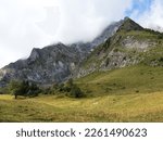Beautiful summer landscape in the French Alps with mountains, clouds and meadow. Haute savoie, Col des Aravis, France