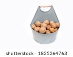 Walnuts In A Bucket On A White...