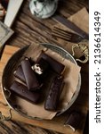 glazed with chocolate cheese bars food photo in rustic style top view with copy space. homemade cheese and choco sweets on wooden table