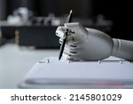 artificial robotic arm write down some notes with pen