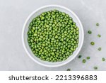 Green Gram. Organic Mung Beans in bowl on gray stone background. Top view with copy space. Vegan food concept