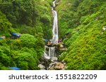 Small photo of Mcleodganj, Himachal Pradesh, India - August, 2019: Majestic landscape of Bhagsu Nag waterfall and green forest around it.