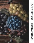 Small photo of blueberries grapes fruit from above on wood backdrop old style faded desecrated texture healthy food tasty good tasty snack green red blue health dieting lifestyle ripe condiments cooking ingredient