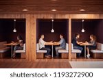 Small photo of Casually Dressed Businessmen And Businesswomen Meeting And Working In Cubicles In Modern Office