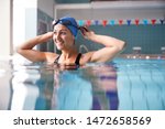 Female swimmer wearing hat and...
