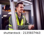 Small photo of Male Worker Operating Fork Lift Truck At Freight Haulage Business