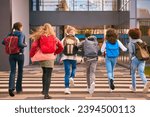 Small photo of Group Of Secondary Or High School Pupils Running Away From Camera Outside School Building