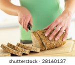 Woman Slicing Mixed Grain Bread