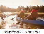 Couple Kayaking On Lake  Back...