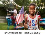 Young black boy holding flag at ...