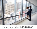 Portrait Of New Business Owners By Empty Office Window
