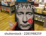 Small photo of 02-17-2016 Amsterdam, Netherlands. Book about Putin with his photo on cover: cold vile mug of a dictator