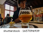 Small photo of Bruges, flanders, Belgium. August 2019. Interior of the historic de garre brewery. A mug of fine craft beer was served with a few pieces of cheese, the tasting takes place in this old-fashioned habit