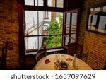 Small photo of Bruges, flanders, Belgium. August 2019. Interior of the historic de garre brewery. The wooden beams, the furniture, the brick walls announce a jump into the past.