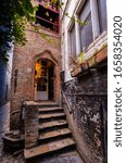 Small photo of Bruges, flanders, Belgium. August 2019. The entrance to the historic de garre brewery. Six steps lead to the threshold: the red brick wall and the appearance herald a jump into the past.