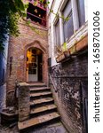 Small photo of Bruges, flanders, Belgium. August 2019. The entrance to the historic de garre brewery. Six steps lead to the threshold: the red brick wall and the appearance herald a jump into the past.