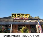 Small photo of Liberty, Missouri USA - November 6 2021: Sign atop DICKEY'S BARBECUE PIT Restaurant beneath Blue Sky