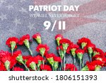Carnations on the memorial with the American flag and the phrase patriots ' Day. September 11. We will never forget. Anniversary of the attack.