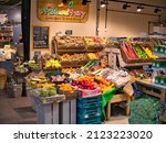 Small photo of Preston, UK - Feb 8 2022: Colourful displays of fresh fruit and vegetables by green grocers in the new Market Hall in Preston, Lancashire, UK.