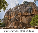 Small photo of Sigiriya, Sri Lanka - Mar 7 2023: Above the Lion Gate, many tourists ascend and descend the steep stairs to the top of the ancient rock fortress of Sigiriya or Lion Rock in central Sri Lanka.