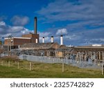 Small photo of Lerwick, UK - May 1 2023: The buildings, chimneys and electrical infrastructure of Lerwick Power Station in Gremista, Lerwick, Shetland, UK.