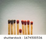Small photo of Matchsticks burn, one piece prevents the fire from spreading - the concept of how to stop the coronavirus from spreading: isolation, stay at home and social distance. Flat lay. Close up.