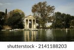 Small photo of Rome, Italy - May 24, 2022, view of the Temple of Aesculapius, located in an artificial islet, in the Garden of the Lake of Villa Borghese.