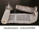 Small photo of Tiberias, Israel. 01.01.23: open Megillat Esther (Book of Esther) isolated scroll on black backround and silver case. Read on the Jewish holiday of Purim.