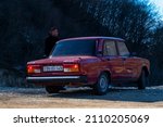 Small photo of Shamakhi, Azerbaijan - January 07 2022- Pulled over red classic sedan car with Azeri driver man in a rural area.
