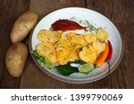 Small photo of Potato snack on a plate, placed on old wooden floors and potato heads