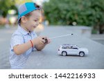 A Boy Playing With A Car Remote....