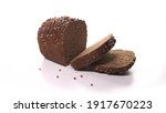 Small photo of beautiful loaf of black sliced bread, ready for breakfast with sprinkles spinn on white background. Fresh bread, just from the oven on turntable isolated.