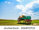 Landscape with sky and  grass, cart with big pumpkin
