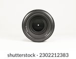 Macro photo of a black 50mm 1.8 lens on a white background with a closed aperture for a photo or video camera