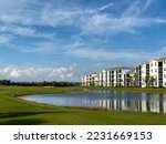 Small photo of Retirement community condos on a resort golf course southwest Florida. Blue skies with water and lush green turf
