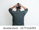 Back view of a man grabbing his head showing stress gesture